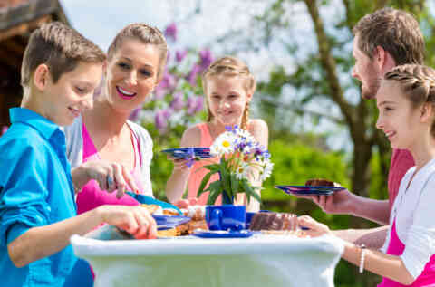Family having coffee and cake in garden 479043644 1262x834
