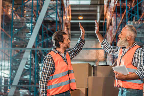 Warehouse workers with digital tablet 909613070 726x484