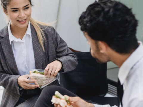 Adults eating sandwiches