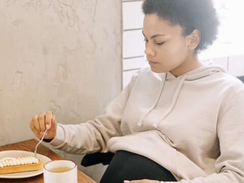 Pregnant woman eating dessert